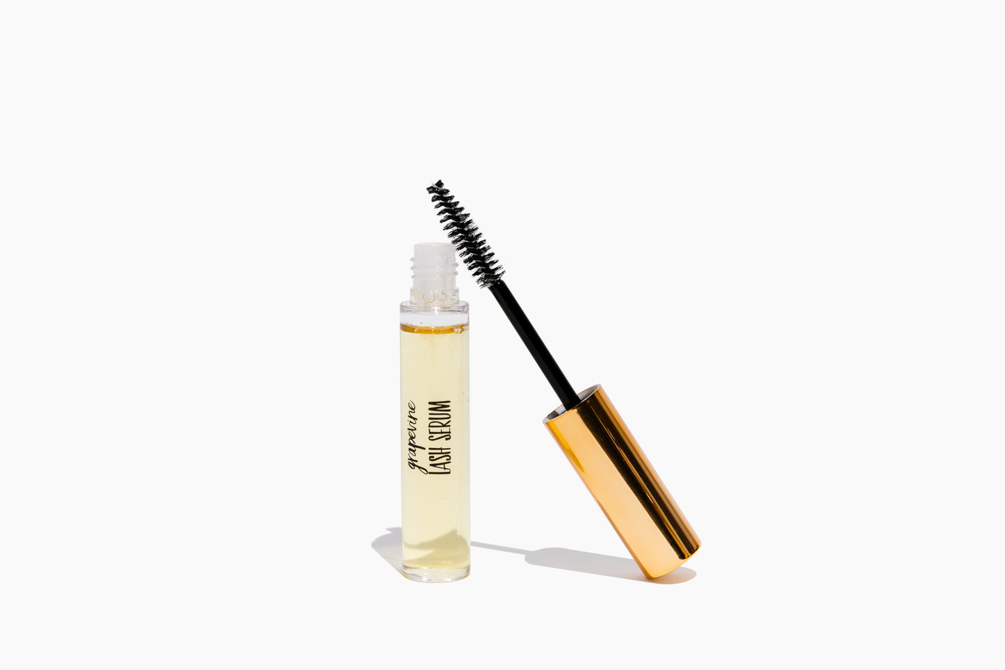 A bottle of Grapevine Lash Serum with a applicator wand and brush, against a white background.